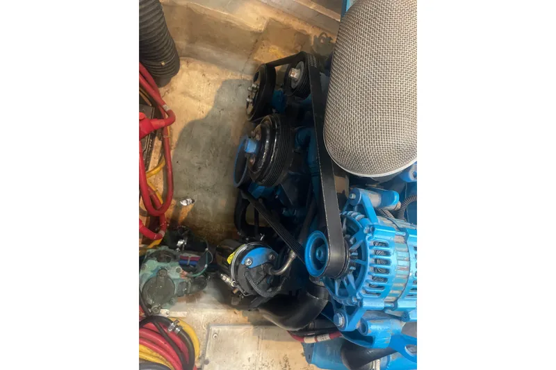 Slide: The Image of Engine compartment of 2008 Carver 41 Cockpit Motor Yacht, featuring blue components and wiring. - 41