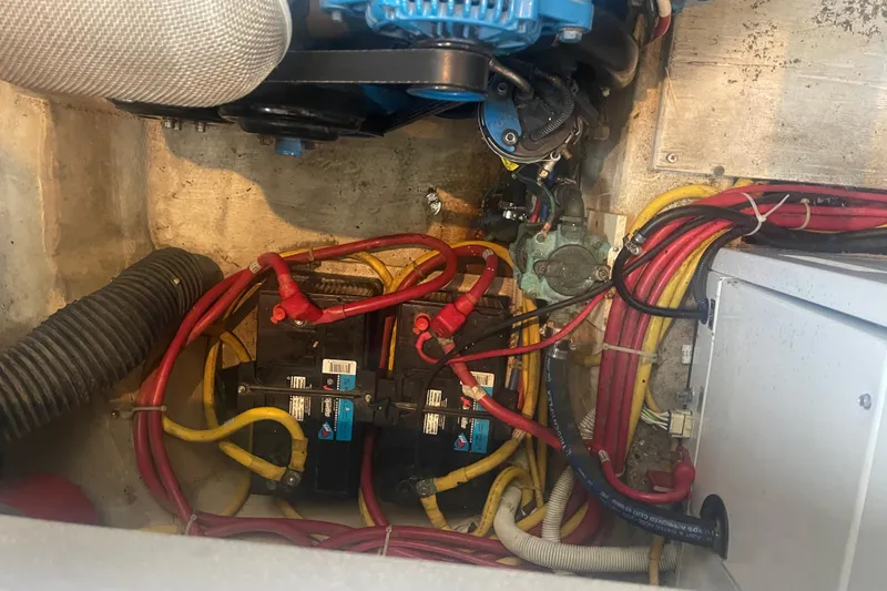 Slide: The Image of Engine compartment of a 2008 Carver 41 Cockpit Motor Yacht with batteries and wiring. - 42