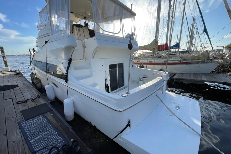 Slide: The Image of 2008 Carver 41 Cockpit Motor Yacht docked at marina, showcasing sleek design and spacious cockpit. - 7