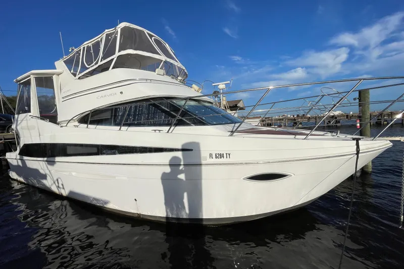 Slide: The Image of 2008 Carver 41 Cockpit Motor Yacht docked under clear blue sky. - 8