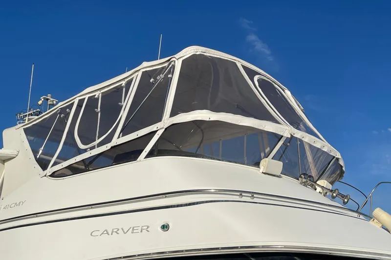 Slide: The Image of 2008 Carver 41 Cockpit Motor Yacht with enclosed flybridge under clear blue sky. - 9