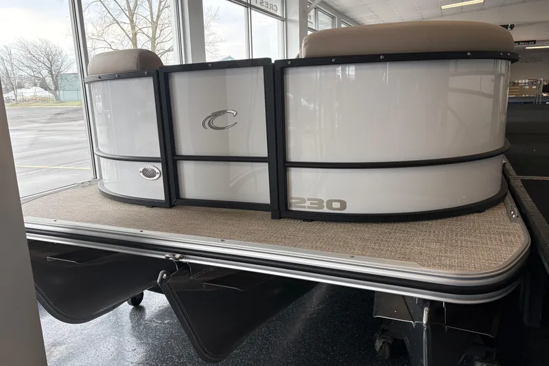 Slide: The Image of Crest 230SLC Conquest 2026 pontoon boat in showroom. - 2