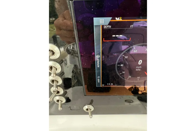 Slide: The Image of Close-up of a 2018 Sportsman Open 232 Center Console dashboard display showing depth and speed. - 10