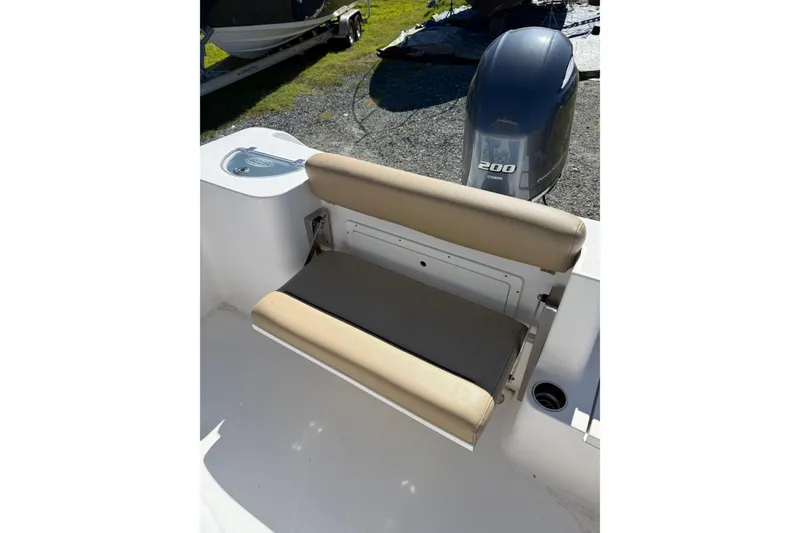 Slide: The Image of 2018 Sportsman Open 232 Center Console boat with beige seating and Yamaha 200 engine. - 11