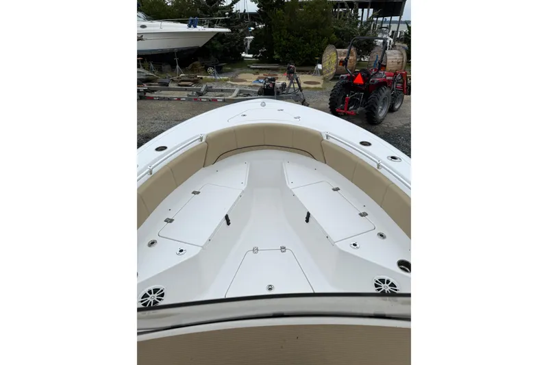 Slide: The Image of 2018 Sportsman Open 232 Center Console boat with spacious seating and storage compartments. - 12
