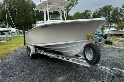 Slide: The Image of 2018 Sportsman Open 232 Center Console boat on trailer in outdoor setting. - 2