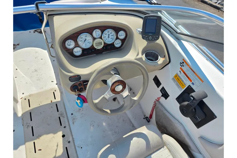 Slide: The Image of 2007 Glastron GT 185 boat dashboard with steering wheel, gauges, and control panel. - 12