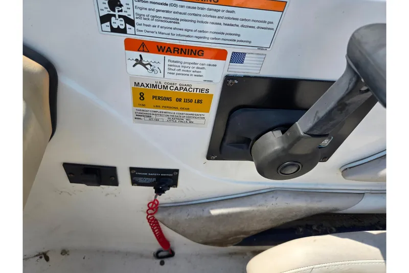 Slide: The Image of 2007 Glastron GT 185 boat control panel with safety warnings and capacity details. - 13