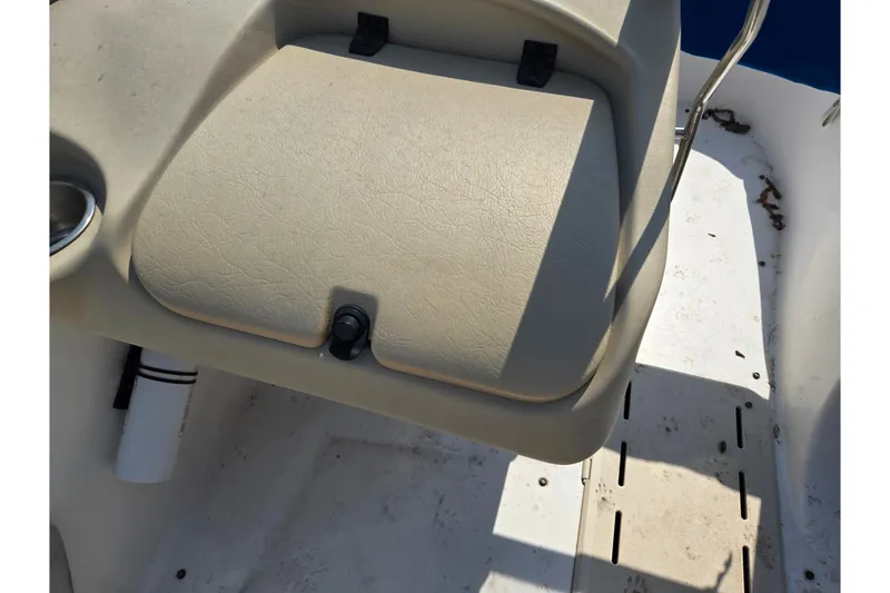Slide: The Image of 2007 Glastron GT 185 boat seat and deck, featuring beige upholstery and cup holder. - 14