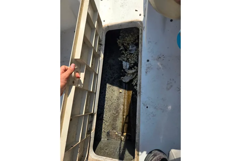 Slide: The Image of Open storage compartment on 2007 Glastron GT 185 boat, showing interior details. - 16