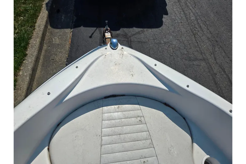 Slide: The Image of 2007 Glastron GT 185 boat bow view on a trailer, parked on pavement. - 18