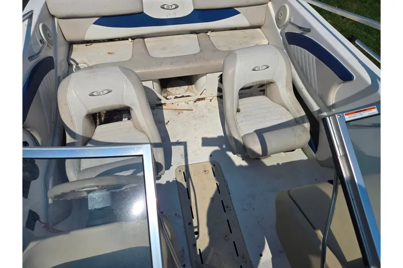 Slide: The Image of 2007 Glastron GT 185 boat interior with white seating and blue accents. - 21