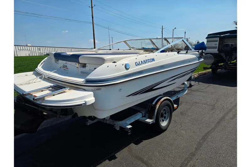 Slide: The Image of 2007 Glastron GT 185 boat on trailer, parked outdoors under clear sky. - 3