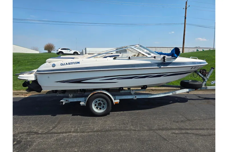 Slide: The Image of 2007 Glastron GT 185 boat on trailer, parked outdoors on a sunny day. - 4