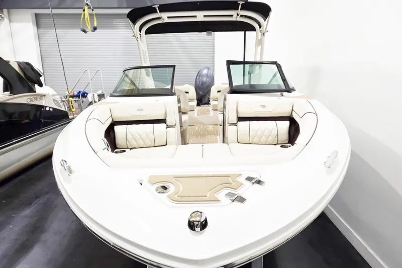 Slide: The Image of 2026 Regal LX2 boat with luxurious seating and sleek design in a showroom. - 4