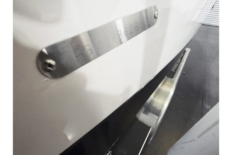 Slide: The Image of 2026 Regal LX2 boat with metal nameplate and sleek design details. - 9