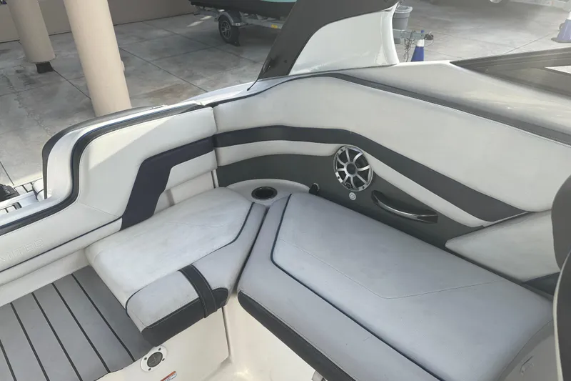 Slide: The Image of Interior seating of 2018 Yamaha Boats 242 Limited S E-Series, featuring sleek design and speaker. - 20