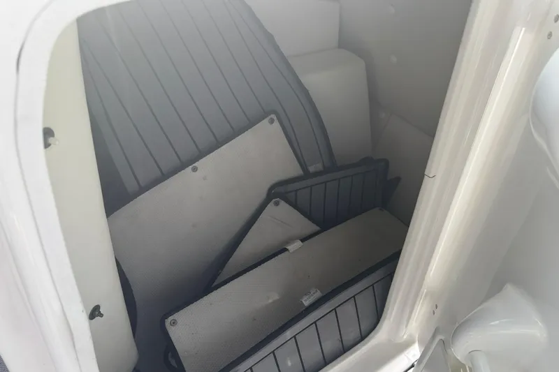 Slide: The Image of Storage compartment of 2018 Yamaha Boats 242 Limited S E-Series with floor mats inside. - 27