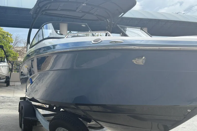 Slide: The Image of 2018 Yamaha Boats 242 Limited S E-Series on trailer, sleek design under a canopy. - 8