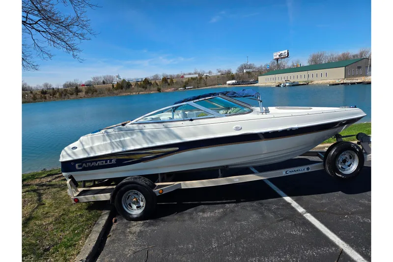 The Image of 2001 Caravelle 188 Bow Rider boat on trailer by a lake. - 0