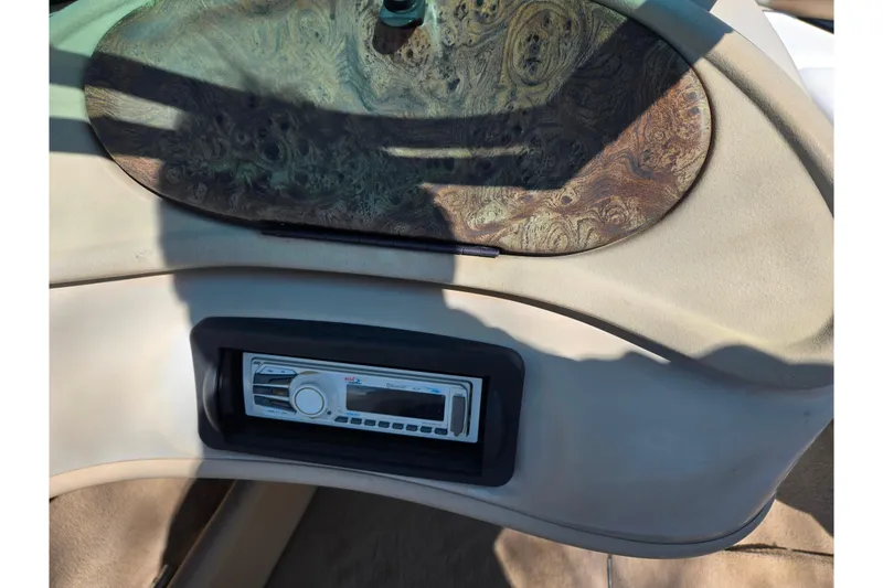 Slide: The Image of 2001 Caravelle 188 Bow Rider dashboard with wood panel and stereo system. - 13