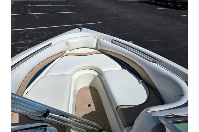 Slide: The Image of 2001 Caravelle 188 Bow Rider boat interior with white and beige seating. - 14