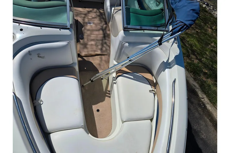 Slide: The Image of 2001 Caravelle 188 Bow Rider interior with white seating and green accents. - 16