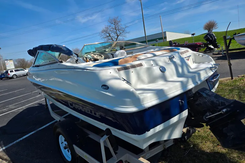 Slide: The Image of 2001 Caravelle 188 Bow Rider boat on trailer in parking lot. - 3