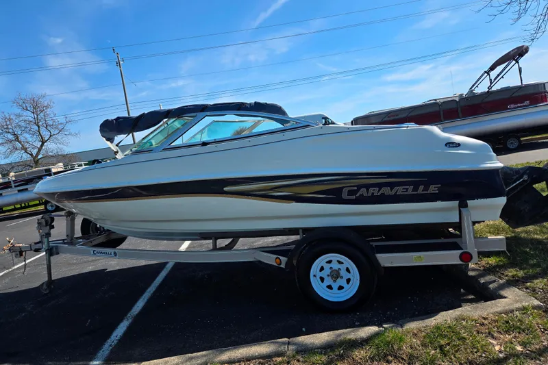 Slide: The Image of 2001 Caravelle 188 Bow Rider boat on trailer in parking lot. - 4