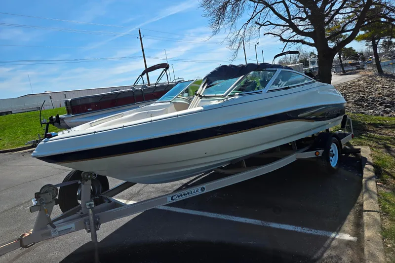 Slide: The Image of 2001 Caravelle 188 Bow Rider boat on trailer in parking lot. - 5