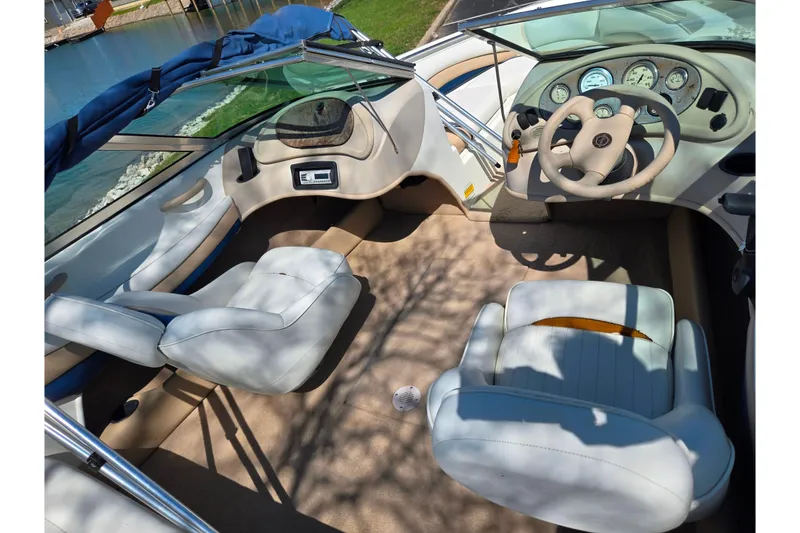 Slide: The Image of Interior of a 2001 Caravelle 188 Bow Rider boat with white seating and dashboard. - 9