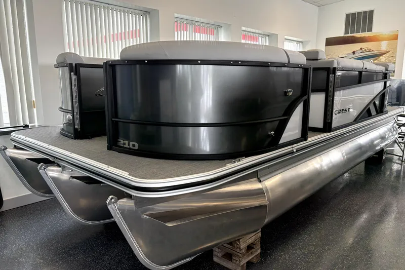 The Image of 2026 Crest 210L Conquest pontoon boat in showroom, sleek design, metallic finish. - 1