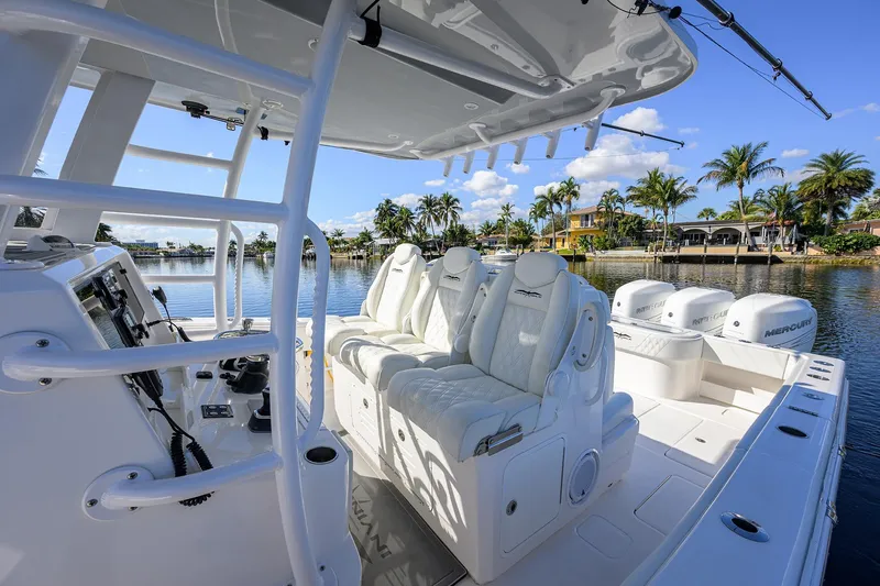 Slide: The Image of 2021 Invincible 39 Open Fisherman boat interior with luxurious seating and scenic waterfront view. - 25