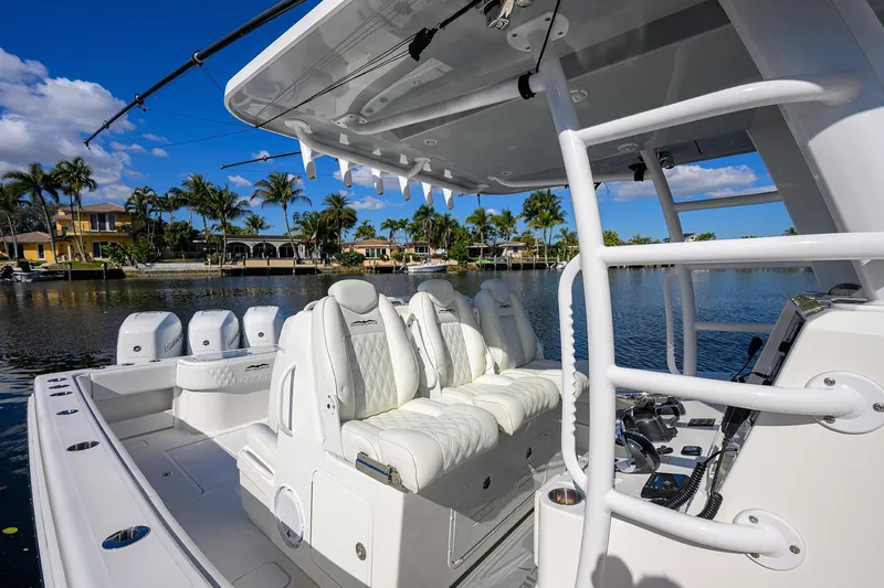Slide: The Image of 2021 Invincible 39 Open Fisherman boat with luxurious seating and scenic waterfront view. - 26