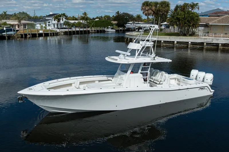 Slide: The Image of 2021 Invincible 39 Open Fisherman boat on calm water, showcasing sleek design and powerful engines. - 3