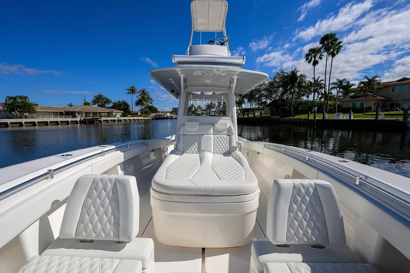 Slide: The Image of 2021 Invincible 39 Open Fisherman boat with luxurious seating on a sunny waterfront. - 38