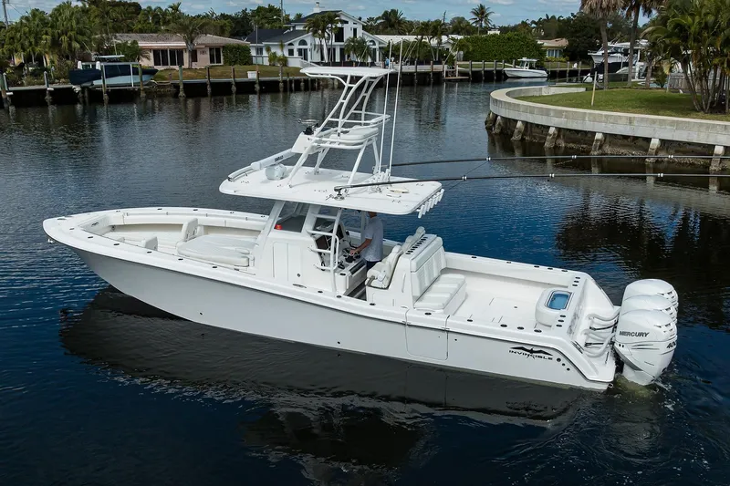 Slide: The Image of 2021 Invincible 39 Open Fisherman boat on calm water, featuring triple Mercury engines. - 4