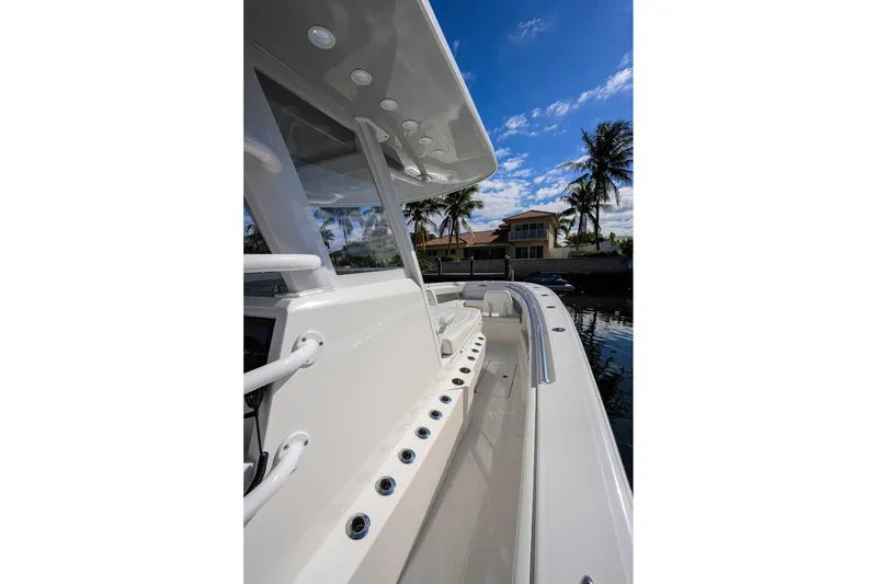 Slide: The Image of 2021 Invincible 39 Open Fisherman boat docked, showcasing sleek design and spacious deck. - 45