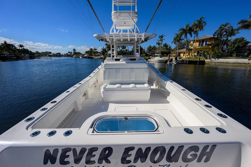 Slide: The Image of 2021 Invincible 39 Open Fisherman boat on a sunny waterfront, featuring spacious seating. - 51