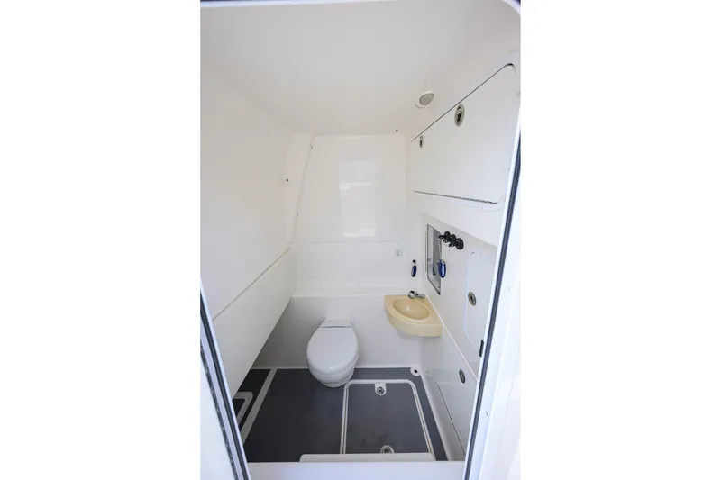 Slide: The Image of Interior of 2021 Invincible 39 Open Fisherman boat bathroom with toilet and sink. - 62