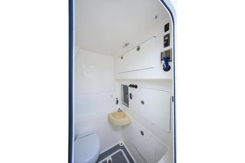 Slide: The Image of 2021 Invincible 39 Open Fisherman boat interior bathroom with sink and storage compartments. - 64