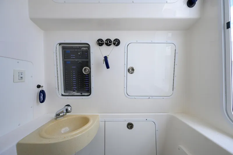 Slide: The Image of 2021 Invincible 39 Open Fisherman interior with control panel and sink. - 66