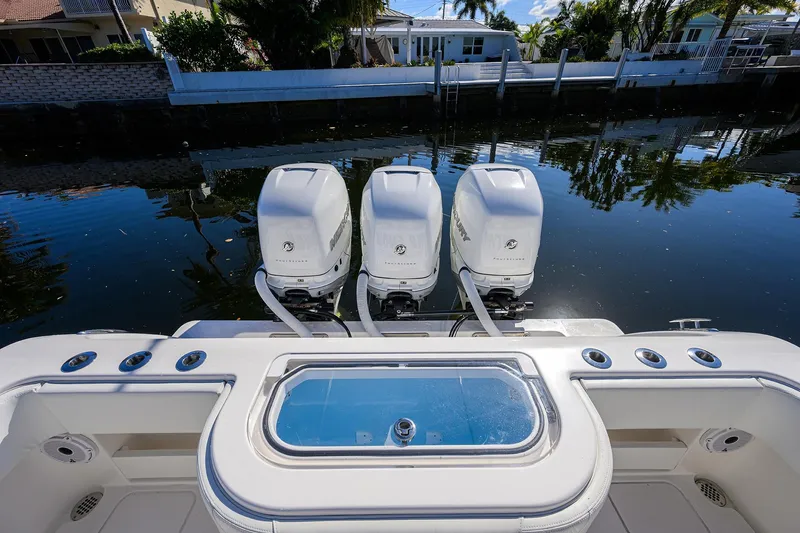 Slide: The Image of 2021 Invincible 39 Open Fisherman with triple outboard engines on a calm waterway. - 72