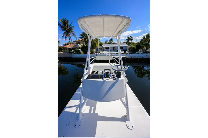 Slide: The Image of 2021 Invincible 39 Open Fisherman boat docked, featuring a sleek design and canopy. - 80