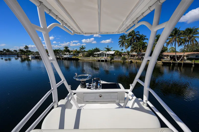 Slide: The Image of 2021 Invincible 39 Open Fisherman boat on a serene waterway with palm trees. - 83