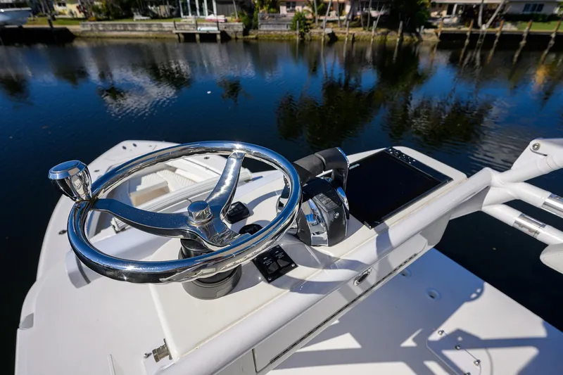 Slide: The Image of Steering console of 2021 Invincible 39 Open Fisherman boat by a calm waterfront. - 86