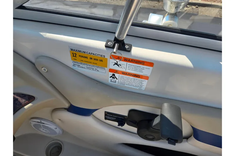 Slide: The Image of 2005 Glastron GX 235 boat capacity warning label, maximum 12 persons or 1650 lbs. - 14