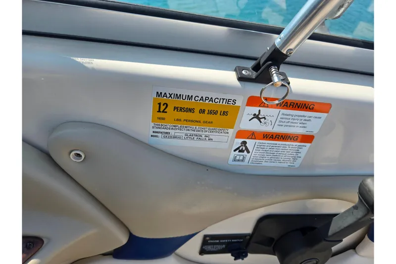 Slide: The Image of 2005 Glastron GX 235 boat capacity warning label, maximum 12 persons or 1650 lbs. - 16