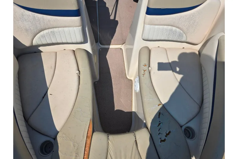 Slide: The Image of Worn interior seating of a 2005 Glastron GX 235 boat, showing visible damage and wear. - 19