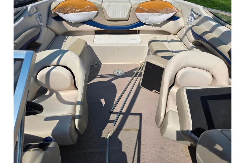 Slide: The Image of 2005 Glastron GX 235 boat interior with beige seating and carpeted floor. - 21